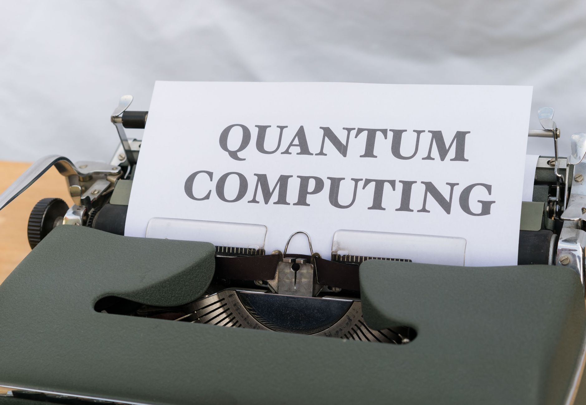 A vintage typewriter with a paper displaying the term Quantum Computing.