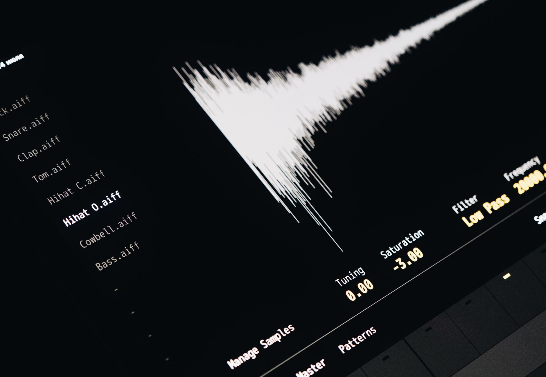 Close-up of a digital audio editing interface displaying sound waves and file names.