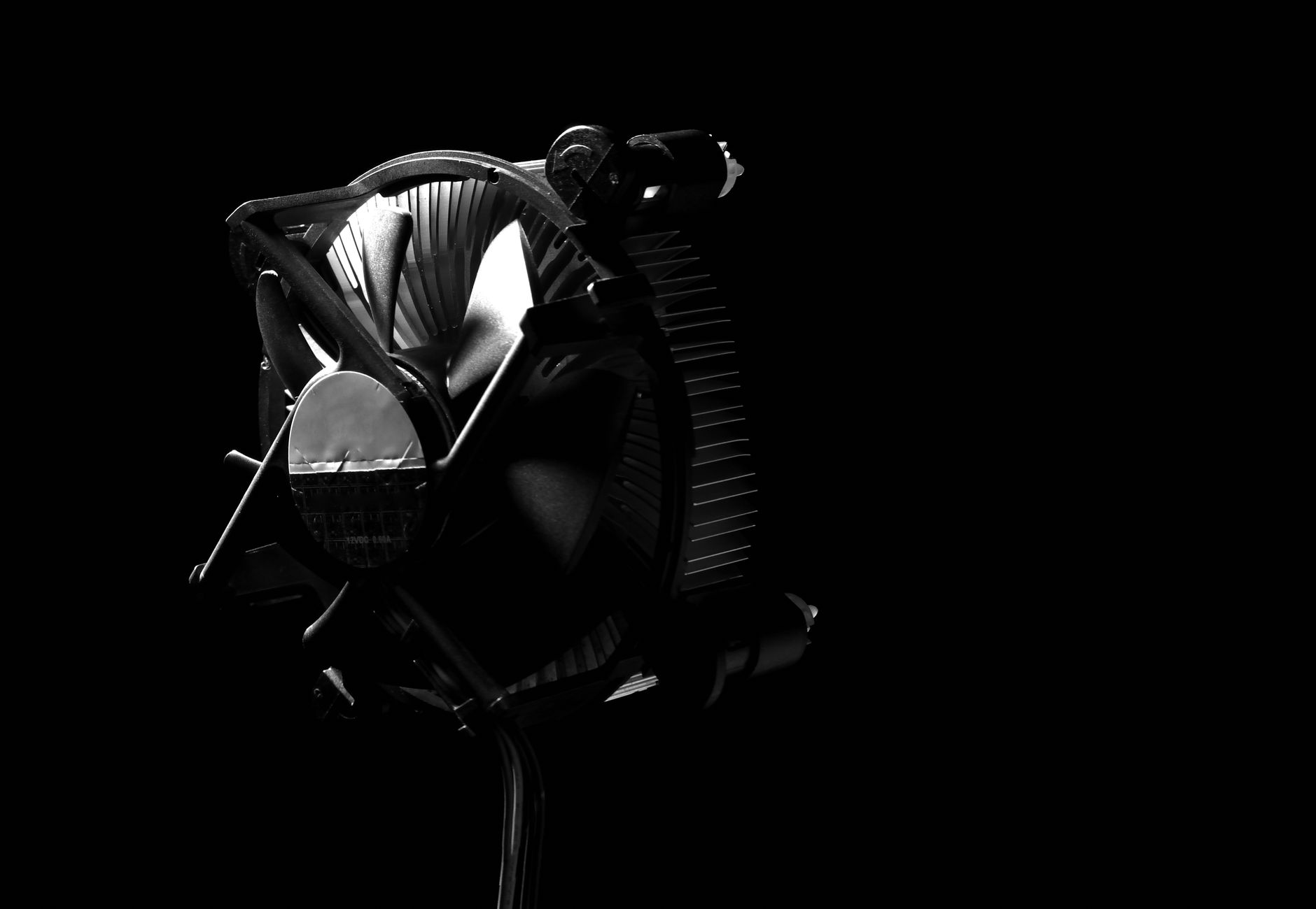 Elegant black and white photo of a CPU cooler with dramatic shadows, perfect for technology themes.